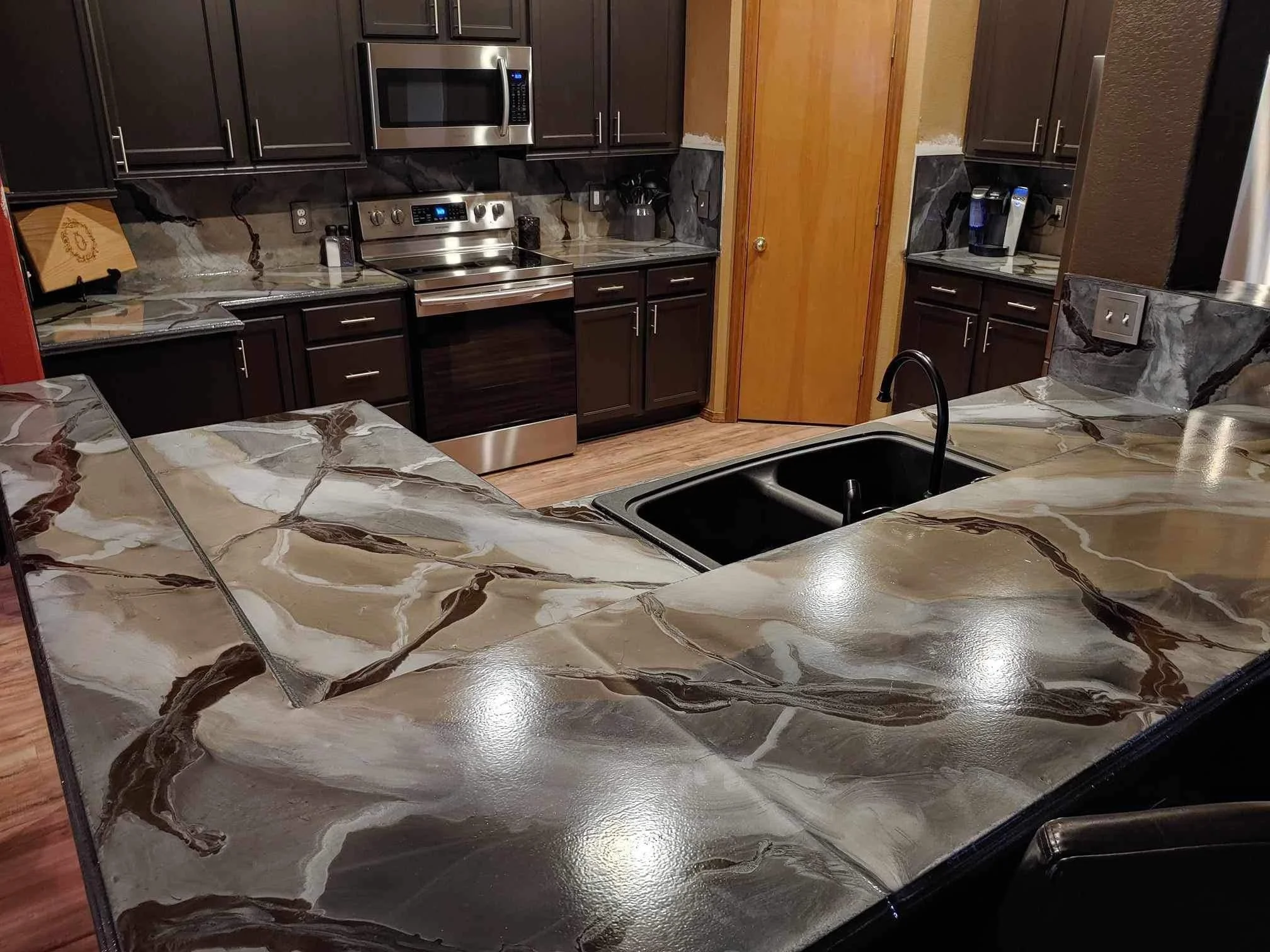 Custom concrete countertop with metallic epoxy finish in a modern kitchen